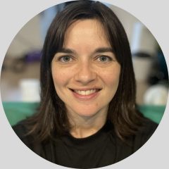 Photo of woman looking to camera and smiling.